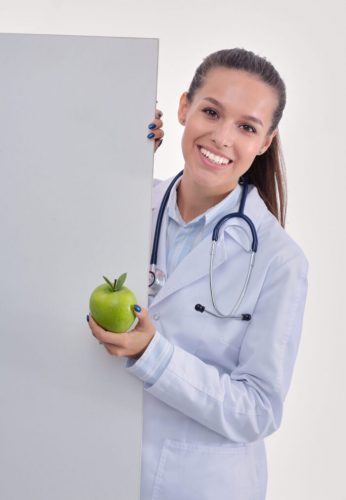 Smiling doctor with apple and blank banner. Woman doctors.
